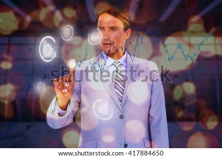 Handsome businessman touching invisible screen against modern room overlooking city