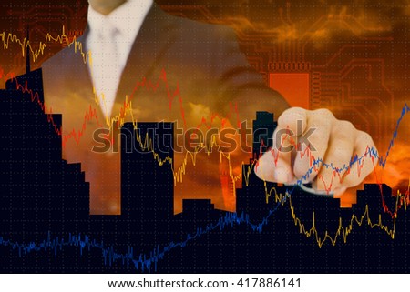 Smiling businessman in suit pointing against cityscape design