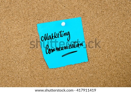 Marketing Communication written on blue paper note pinned on cork board with white thumbtacks, copy space available