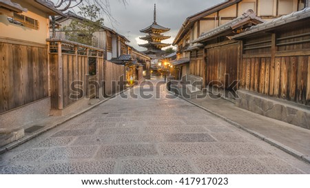 Beautiful empty traditional Japanese street with the Yasaka pagoda in the background in the evening with the lights on.
