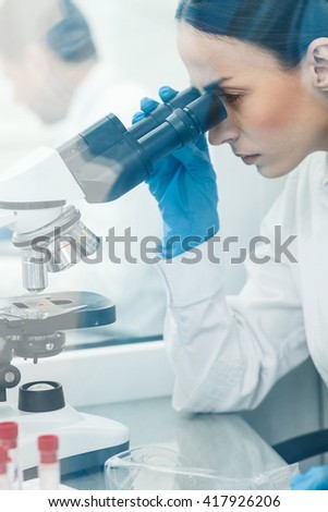 Skillful female chemist is working in laboratory