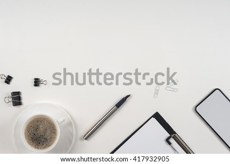 Business blank, notepad,  coffee cup and pen at office desk table top view. Corporate stationery branding mock-up.  Copy space for text.