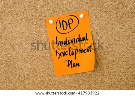Business Acronym IDP Individual Development Plan written on  yellow paper note pinned on cork board with white thumbtack, copy space available Royalty-Free Stock Photo #417933922
