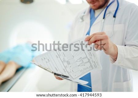 Doctor watching medical record of a patient Royalty-Free Stock Photo #417944593