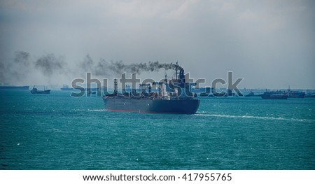 Black Smoke from Ship Sailing on the High Sea Royalty-Free Stock Photo #417955765