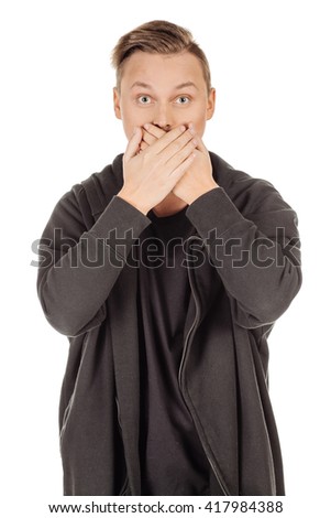 Portrait of a young man covering his mouth with hand. human emotion expression and lifestyle concept. image on a white studio background.