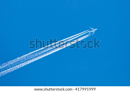 Large aircraft flying in sky, 4 stripes in the sky