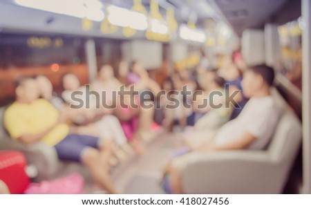 Abstract blur image of inside the bus with  passenger for background usage . (vintage tone)