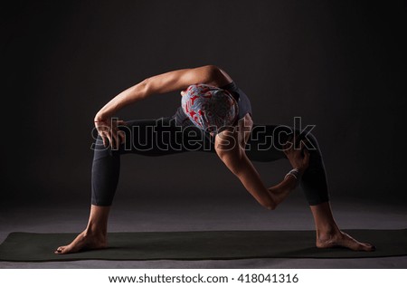 Practice yoga, fitness and gymnastics. young girl on a dark background