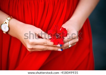 red flower in female hand