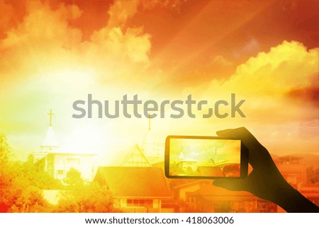 Photographing with smartphone in hand  at sunset. Travel concept. hope concept