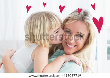 Red Hearts against mother sitting on the couch with her daughter kissing her cheek