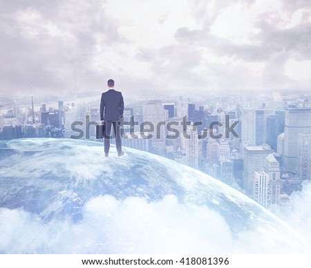Businessman standing with his briefcase on a picture of the earth