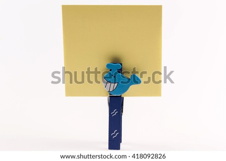 Clothespin with note on white background