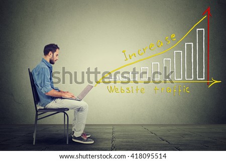 Young man using a laptop. IT guy young man working on notebook has a plan to increase website traffic. Technology marketing concept Royalty-Free Stock Photo #418095514