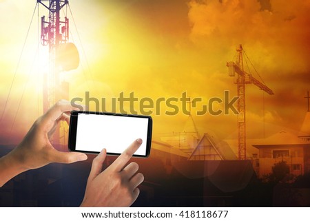 Hand with a smartphone take photo a antenna. Sunset background. communicate concept