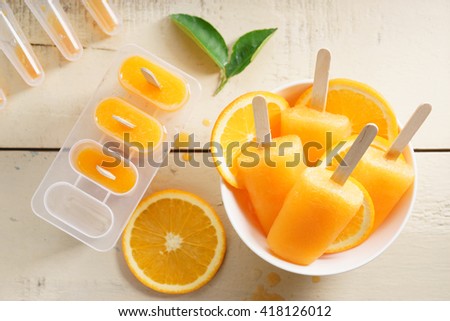 orange ice pops fresh summer fruit sweet dessert in a yellow polka dot cup