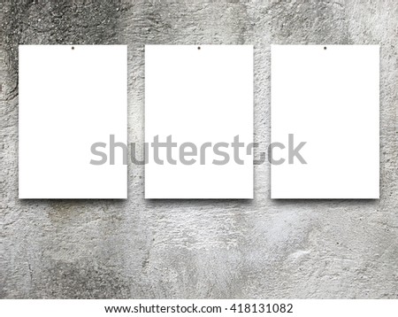 Close-up of three nailed blank frames on stained concrete wall background