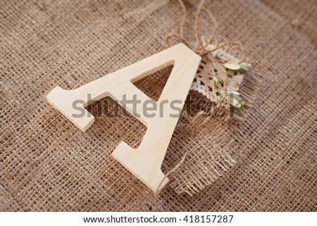 Wooden letter "A" on sacking background