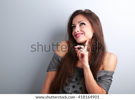 Thinking fashion young female model looking up on empty copy space background