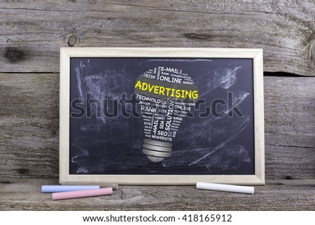 ADVERTISING bulb word cloud. Chalk board on a wooden table