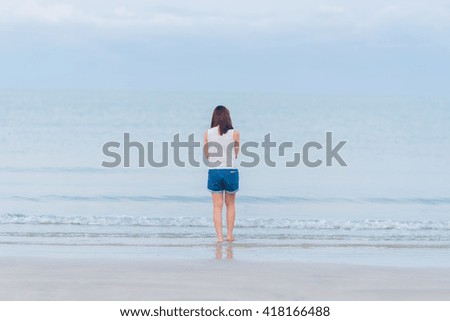 girl standing on the beach
