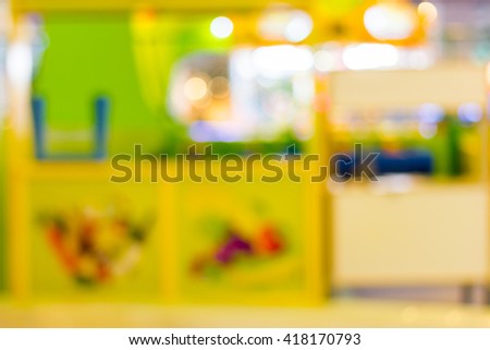 Blur image of playground in the mall use for background.