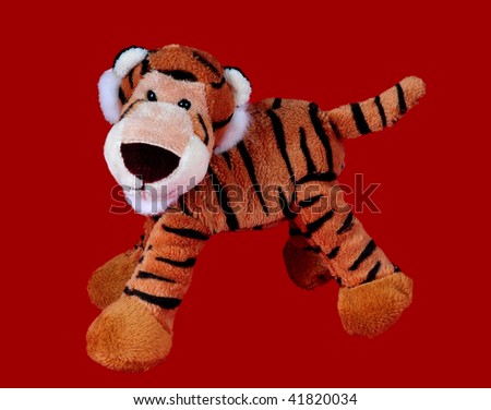 Plush tiger macsot toy on clear red background Royalty-Free Stock Photo #41820034