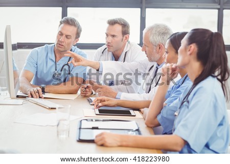 Medical team interacting at a meeting in conference room in hospital