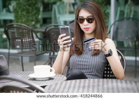 Lady buying online with a credit card and smart phone