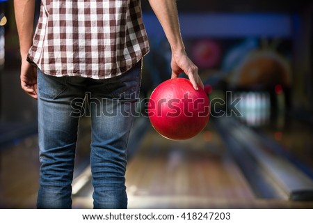 Man's hand with ball in bowling