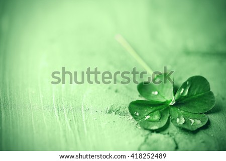 St. Patricks day,  clover leaf on green wooden background Royalty-Free Stock Photo #418252489