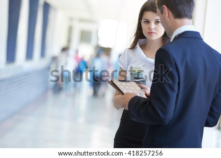business woman hold money and a businessman hold a tablet