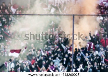 crowd of soccer fans at the stadium - defocused background