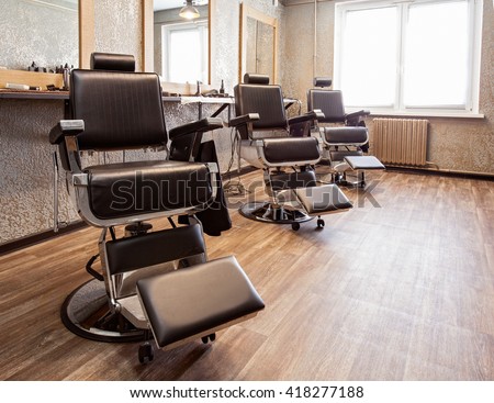 Interior of a barbershop, armchairs for clients Royalty-Free Stock Photo #418277188
