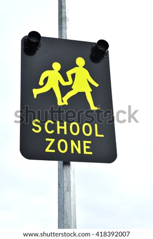 School zone street sign on metal pole.
