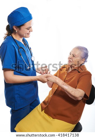 doctor and patiend looking at each other and holding hands