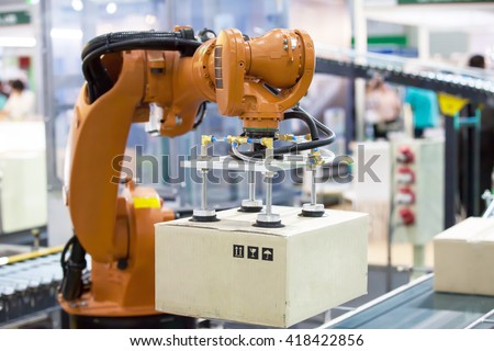 Industrail Robotic Arm for holding a package Royalty-Free Stock Photo #418422856
