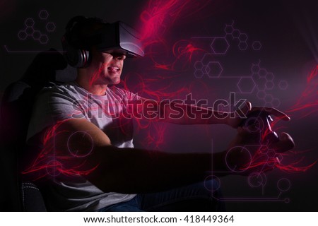 Young man playing a virtual reality video game Royalty-Free Stock Photo #418449364