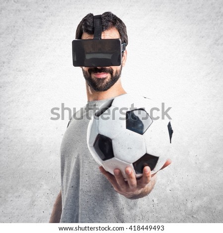Man playing soccer using VR glasses