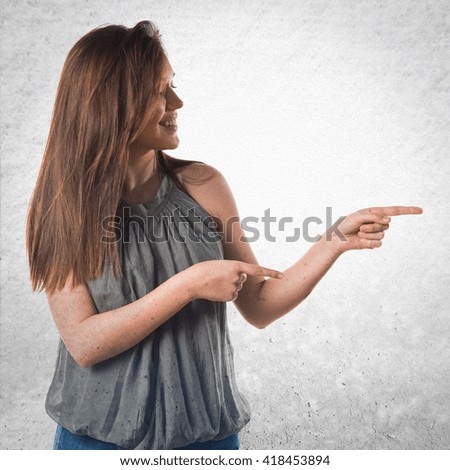 Young girl pointing to the lateral