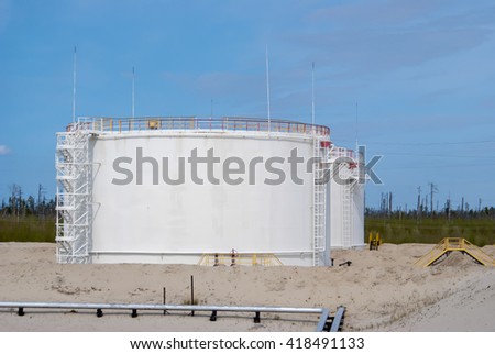 Oil reservoir on a background of blue sky