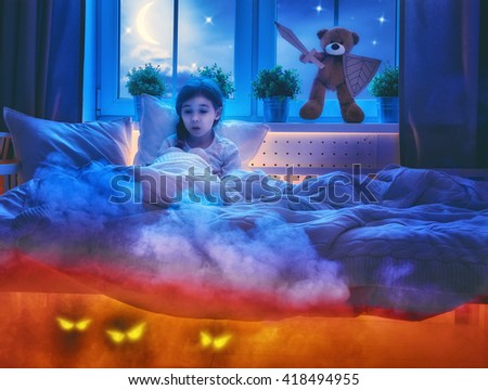 Nightmare for children. Little child girl is afraid of monsters in the dark of night. Frightened little girl and her teddy bear friend are protected against monsters.