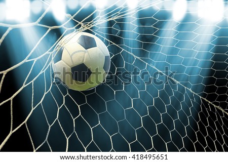 soccer ball in goal with spotlight Royalty-Free Stock Photo #418495651