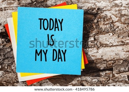 Word quotes of TODAY IS MY DAY on colorful memo papers with wooden background.