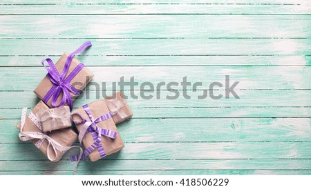 Many  festive gift boxes with presents on turquoise wooden background. Selective focus. Place for text. Toned image.