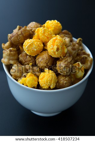 Caramel and cheese popcorn in a cup.