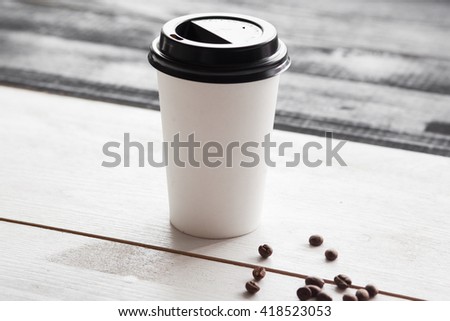 Paper coffee cup for logo, wooden table vintage style