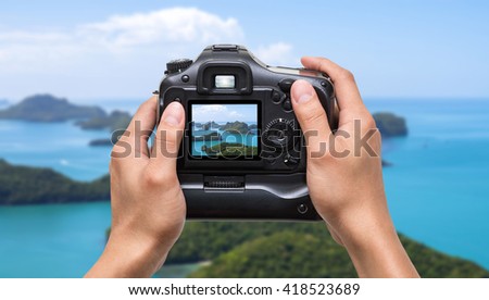 Hands holding the camera which taking photo of Top view of Ang Thong National Marine Park with rainbow, Thailand