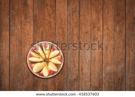 Top view of sliced apple on wooden background, stock photo